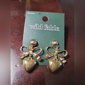 Wild Fable brand gold-tone earrings feature a bow and heart dangle design.